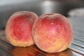 Rosy ripe Kuban peach close-up on a metal table