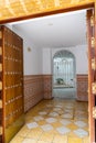 Typical Andalusian entrance foyer with colorful tiles and grated door leading to the interior patio Royalty Free Stock Photo