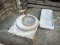 Rotary discoid mill stone for hand-grinding a grain into flour. Medieval hand-driven millstone grinding wheat. The Royalty Free Stock Photo