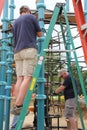 Rotary members from the community helping to build a playground for children.