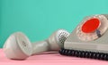 A rotary retro phone on a desk against a mint green wall Royalty Free Stock Photo