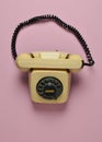 Rotary retro phone on a pink pastel background. Hot line. Top view. Royalty Free Stock Photo