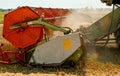 Rotary straw walker combine harvester cuts and threshes ripe wheat grain. Platform grain header with thresher reel