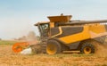 Rotary straw walker cut and threshes ripe wheat grain. Man in combine harvesters with grain header, wide chaff spreader