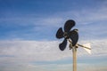 Rotary vane indicates the direction of the wind against the blue sky Royalty Free Stock Photo