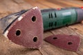 Rotary wood grinder with old sandpaper. Work tool in a carpentry workshop