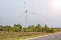 Rotating blades of a windmill propeller on blue sky background. Wind power generation. Pure green energy Royalty Free Stock Photo