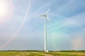 Rotating blades of a windmill propeller on blue sky background. Wind power generation. Pure green energy Royalty Free Stock Photo