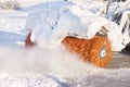 Rotating brush of a snowblower at work close up