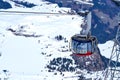 Rotating cable car of Titlis glacier approaching summit station