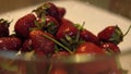 Rotating glass bowl with fresh and ripe strawberries Close up