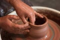 Rotating potter`s wheel and clay ware on it taken from above. A sculpts his hands with a clay cup on a potter`s wheel. Royalty Free Stock Photo