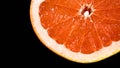 Rotating Sliced red grapefruit isolated on black background Royalty Free Stock Photo