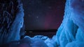 Rotating stars and north light above frozen lake.