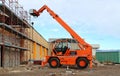 Rotating telehandler at work in an industrial redevelopment area.