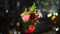 Rotation of bouquet of carnation flowers with twinkling blurred city night lights. romantic concept for lovers and valentine