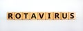 Rotavirus symbol. Wooden cubes with the word `rotavirus`. Beautiful white table, white background. Medical, virus or rotavirus
