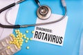 Rotavirus word written on medical blue folder with patient files