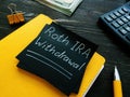 Roth IRA withdrawal words on a black page.