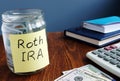 Roth ira written on a label of jar with money