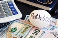 Roth 401k written on a side of egg and money.