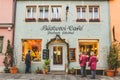 People looking at the shop window of the Bakery Cafe on Galgengasse street in Rothenburg ob der Tauber in Germany