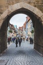 The view of an old town of the Rothenburg ob der Tauber in Germany through the arch in a wall