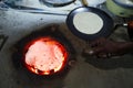 Roti chappati being headted and inflated being cooked on a village country made earthen stove with red hot coal