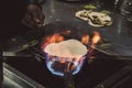 A roti indian flatbread cooking on a coal fire.
