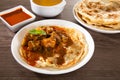 Roti Parata or Roti canai with lamb curry sauce