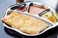 Roti prata or canai set with curry, dhal and sambal Royalty Free Stock Photo