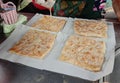 Roti is a type of food made from dough kneaded and then fried or grilled into thin strips.