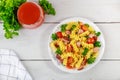 Rotini pasta, ham and vegetables with glass of tomato juice Royalty Free Stock Photo