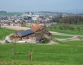 Rotkreuz, Switzerland - April 2nd 2021: Situation of urban sprawl. Urban housing approaches a farm.