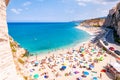 Rotonda beach full of people. Amazing Italian beaches. Sea promenade scenery in Tropea with high cliffs with built on top city