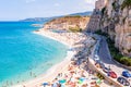 Rotonda beach full of people. Amazing Italian beaches. Sea promenade scenery in Tropea with high cliffs with built on top city