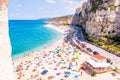 Rotonda beach full of people. Amazing Italian beaches. Sea promenade scenery in Tropea with high cliffs with built on top city