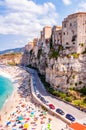 Rotonda beach full of people. Amazing Italian beaches. Sea promenade scenery in Tropea with high cliffs with built on top city