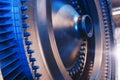 The rotor disk with the blades of a turbojet gas turbine engine with a blue glow