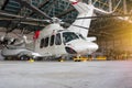 Passenger helicopter and airplanes in the hangar. Rotorcraft and aircrafts under maintenance. Checking mechanical systems for