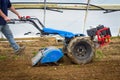 Rototiller tractor unit preparing soil dirt on outdoor garden Royalty Free Stock Photo