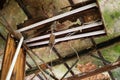 Rotted ceiling and damaged fluorescent light fixture in abandoned building