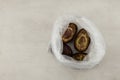 Rotten avocados in plastic bag. Improper food storage. Concept - reduction of organic waste
