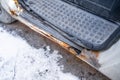 Rotten car footboard. Rusty driver`s door sills. Corrosion of the car body after winter Royalty Free Stock Photo