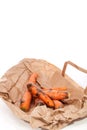 Rotten carrots on supermarket bag. Mouldy vegetables as wasted f