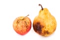 Rotten and decomposing red apple and pear on white background Royalty Free Stock Photo