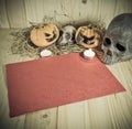 rotten Halloween pumpkin and old paper with candlelight and dry Royalty Free Stock Photo