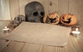 rotten Halloween pumpkin and old paper with candlelight and dry Royalty Free Stock Photo