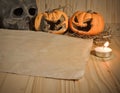 rotten Halloween pumpkin and old paper with candlelight and dry Royalty Free Stock Photo