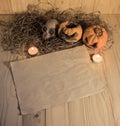 rotten Halloween pumpkin and old paper with candlelight and dry Royalty Free Stock Photo